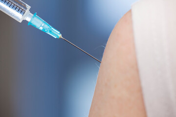 Close-up of vaccination with syringe in upper arm