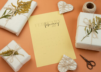 Valentine's Day Zero Waste Concept. Eco-friendly craft paper packaging. Gift Box with a branch of a dried flower tied with jute. Fabruary calendar.
