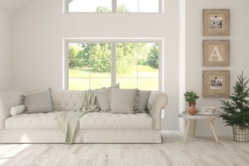 White living room with sofa and summer landscape in window. Scandinavian interior design. 3D illustration