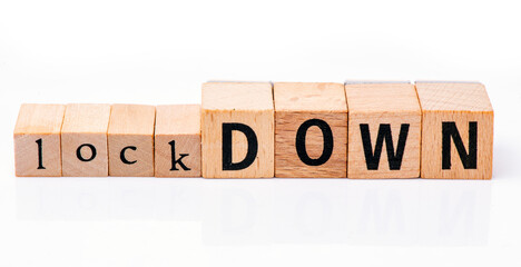 Lockdown text arranged from wooden letters on a white background. Concept in business.