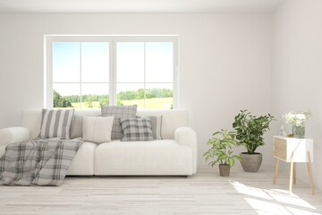 White living room with sofa and summer landscape in window. Scandinavian interior design. 3D illustration