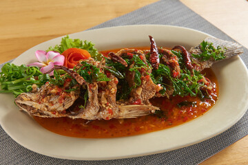 Crispy fried fish topped with delicious dipping sauce, a popular dish.