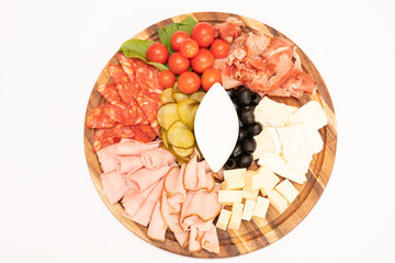 Assorted cold beer snacks on wood plate.