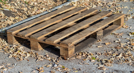 Old wooden pallet on the street on the ground.