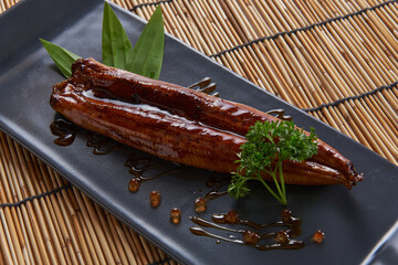 Grilled Eel with Sauce served on a black tile plate The best food of Japan