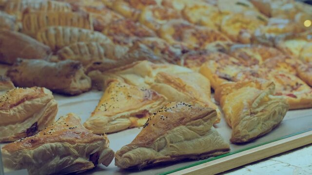 sweet frash pastries for sale behind glass in a cafe