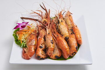Grilled shrimp served on a white plate Popular seafood dishes