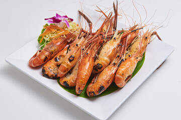 Grilled shrimp served on a white plate Popular seafood dishes