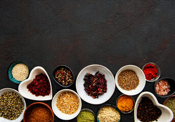 Various spices in a bowls on a black