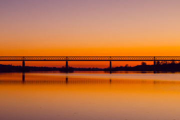 Fototapeta premium Bridge at sunset. Steel bridge over the Tagus river in Chamusca, Portugal