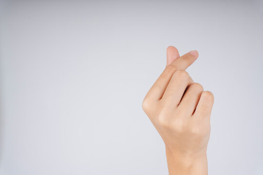 Woman Hand Posing Mini Heart Gesture Isolate Over White Background.