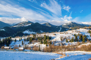 Early spring morning in mountain village. Picturesque clouds. Dzembronya, Ukrainian Carpathians