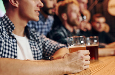 Fans cheer and shout. Group of people together indoors in the pub have fun at weekend time