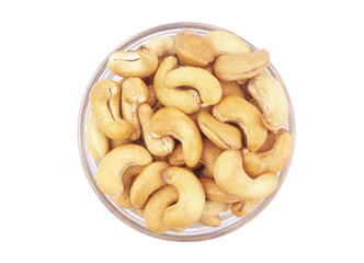Roasted cashew nuts in bowl isolated on white background, top view