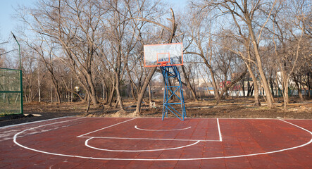 Basketball court outside in autumn.