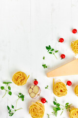 Ingredients for cooking pasta - tagliatelle, tomato, garlic, basil, parmesan cheese
