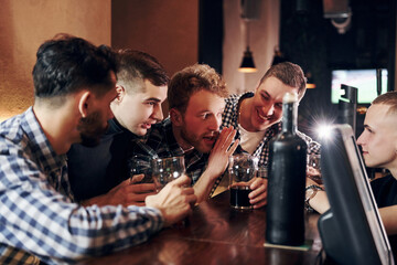 Group of people together indoors in the pub have fun at weekend time