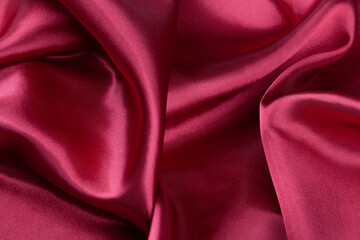 red silk fabric with waves, elegant wallpaper design, abstract background