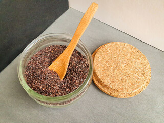 buckwheat in a wooden spoon. Himalayas black rock salt in wood spoon. Food concept