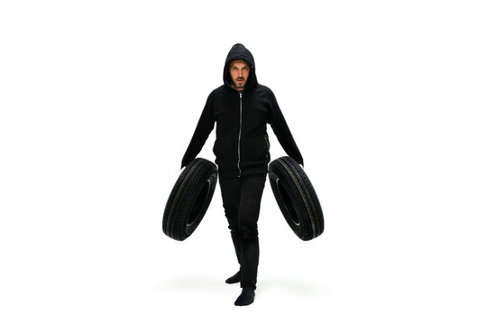 Man holding tires and pretending he is motorbike