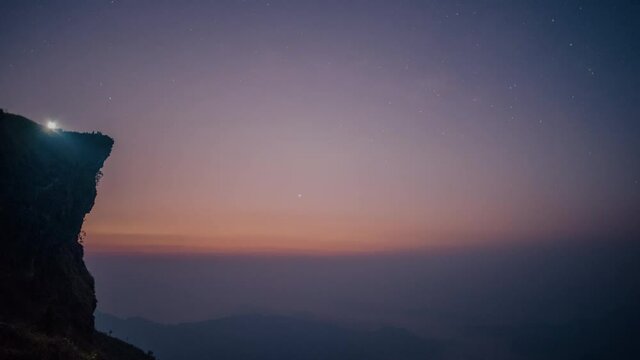 traveler in phu chi fah mountain peak waiting to see beautiful sunrise with fog in early morning, Chiang rai, Thailand. Asia, Landscape, Nature, mist, background, travel, tourism or trekking concept