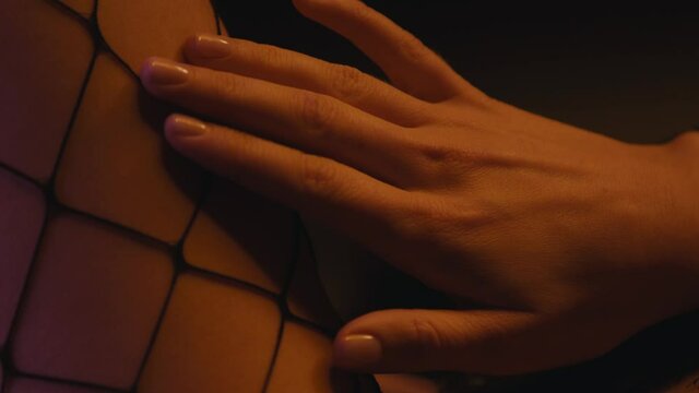 close up of sexy woman touching body on dark background