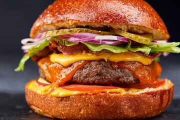 tasty burger with beef cutlet and vegetables