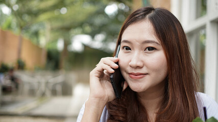 Asian business woman calling at cafe