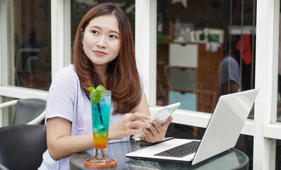 Asian business woman with phone at cafe