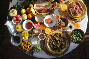 brunch with artichokes mussels croissants fruits brocoli feta salad ham bread and many other food and drink