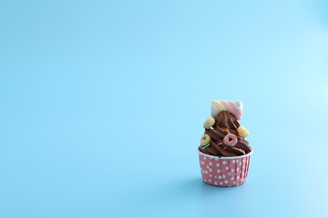 Chocolate cupcake isolated in blue background