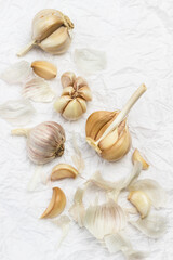 Unpeeled head of garlic, cloves of garlic, and husk