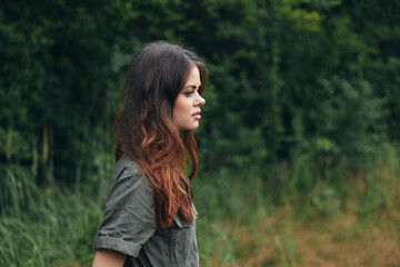 Fototapeta premium Woman in the forest Side view of a pensive view of a fresh air walk nature 