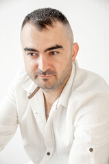 Obraz premium Portrait of a charismatic man with a white shirt. Confident, trustworthy, friendly man, ordinary guy.
