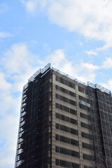 Fototapeta premium Exterior maintenance of a tall building