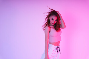 Beautiful asian girl with an afro curly hairstyle in neon light studio.