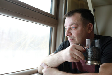 Man drinking tea in train