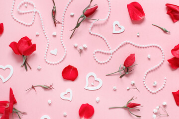 Spring composition with red roses, petals, hearts and pearls over pink background