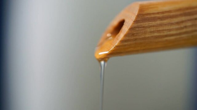 Pure sunflower oil flows through a wooden&nbsp;tube.