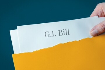 G.I. Bill. Hand opens envelope and takes out documents. Post letter labeled with text