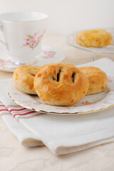 Eccles cakes a small round pastry filled with currants or raisins originating from the town of Eccles in Lancashire England