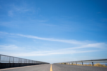 Road and clear sky with clouds
