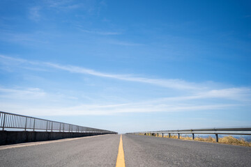 Naklejka premium Highway with blue sky A long road that stretches far