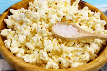 Popcorn in bowl on a blue background. selective focus. close-up. Copy, empty space for text