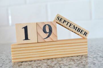 September 19, Cover design with number cube on a white background and granite table.