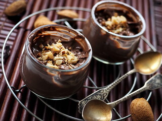 Chocolate mousse with almonds on wooden background

