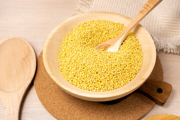 Raw millet groats on wooden background. space for text