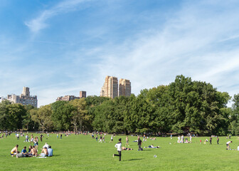Many People Enjoying Central Park On A Nice Day In New York City.