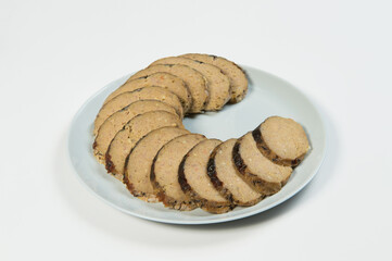 Stuffed carp fish. Jewish traditional gefilte fish slices served on plate isolated on white background. Slices of Minced fish fillet with vegetables
