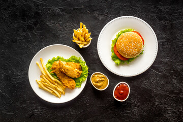 Delicious burgers with french fries and fried chicken. Flat lay, top view